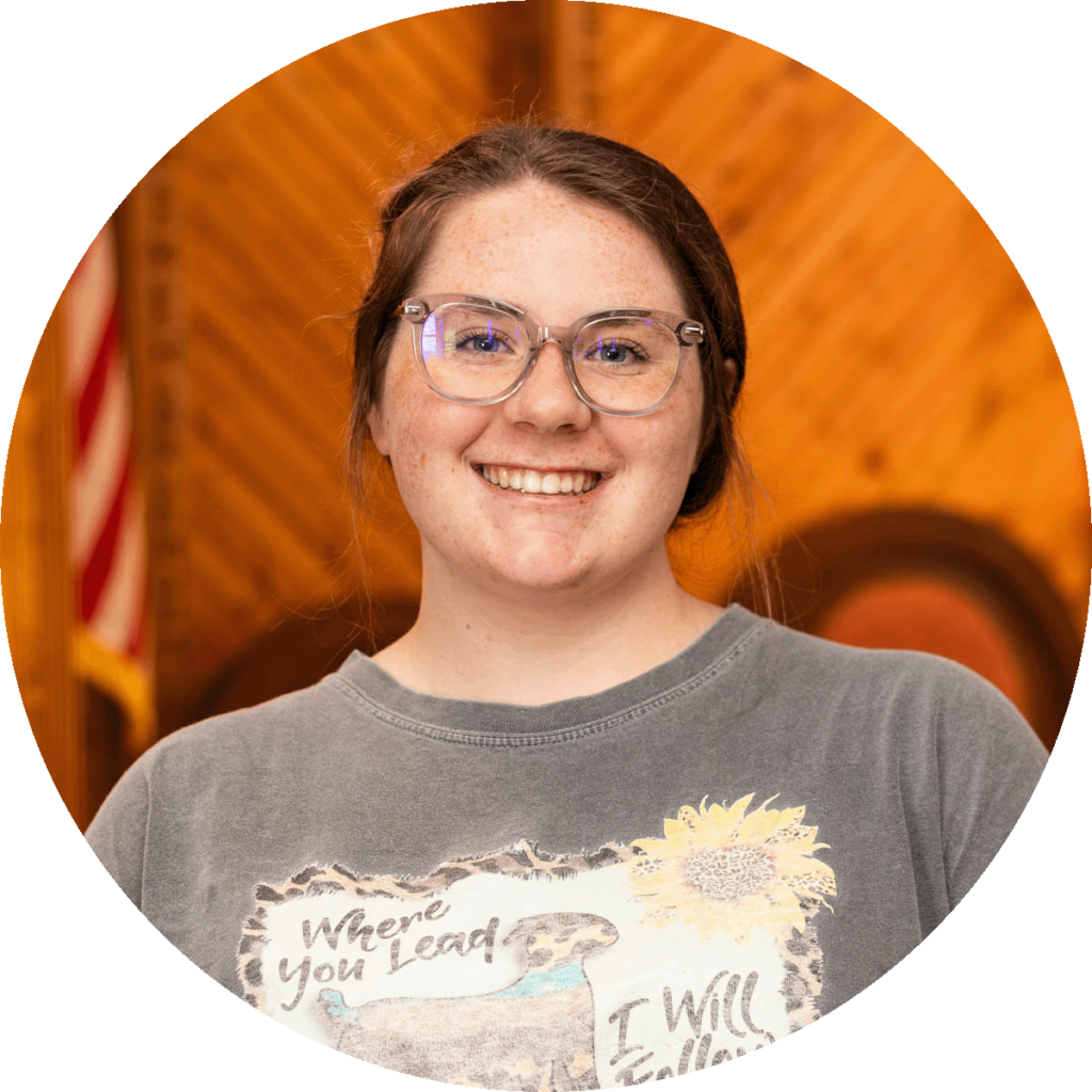 young lady with brown hair and glasses.