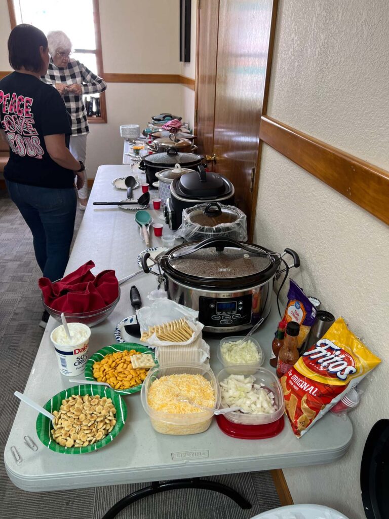 long tables with pots of chili.