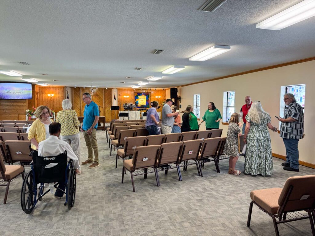 groups of people talking in the church sanctuary.