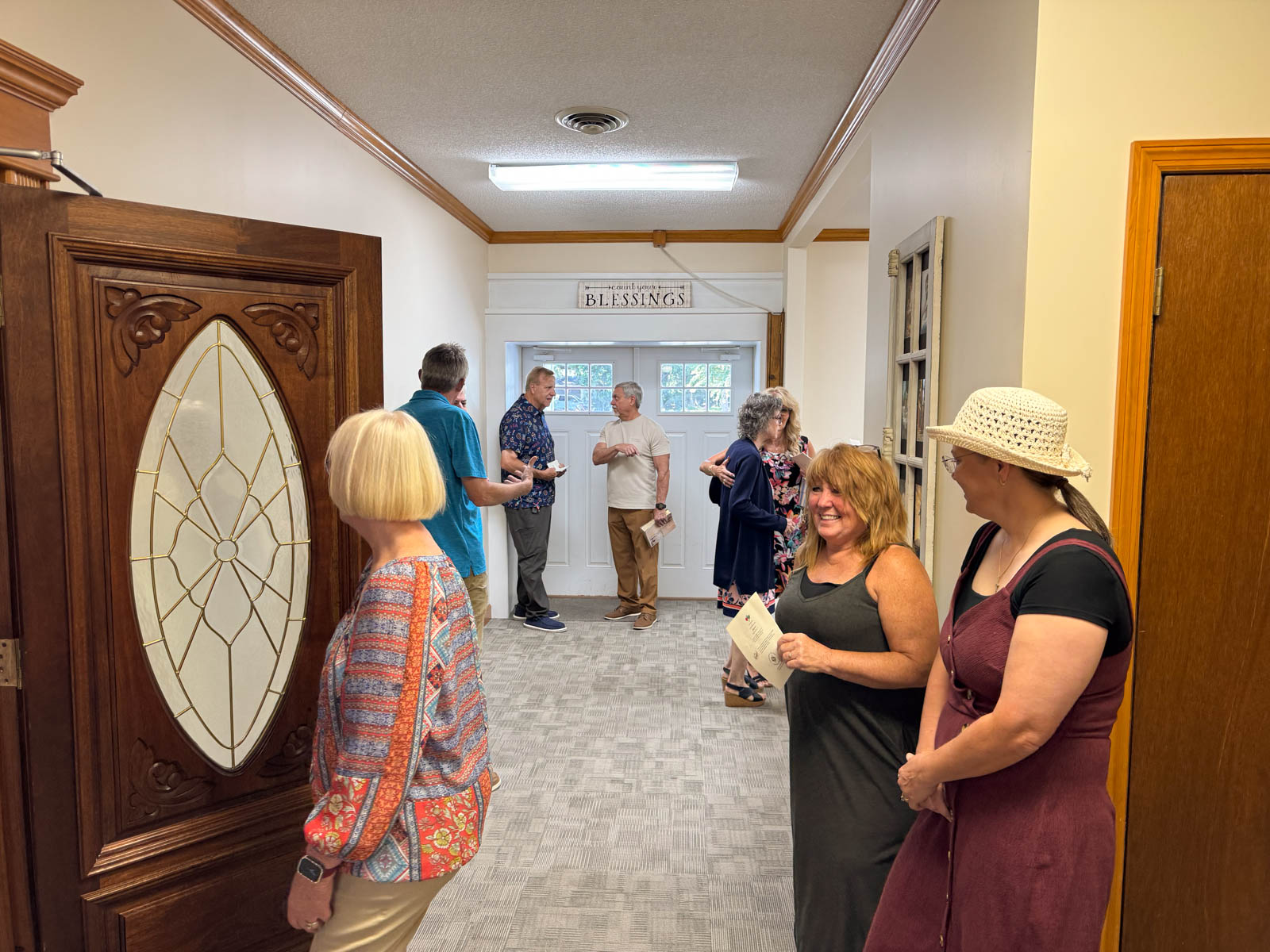 people talking in the church lobby.